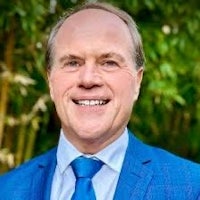 a man wearing a blue suit and tie