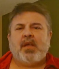 a man in a red shirt with a beard